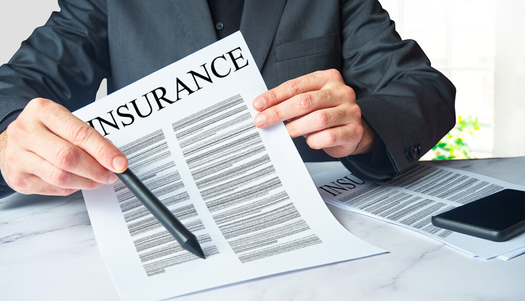 An insurance agent is presenting a policy contract for an unsee