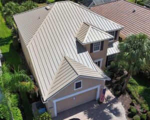 A house with a metal roof surrounded by other houses and greenery.