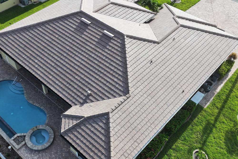 An aerial view of a house showcasing a complex, multi-angled tiled roof
