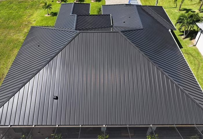 Top-down view of a house with a black metal roof.