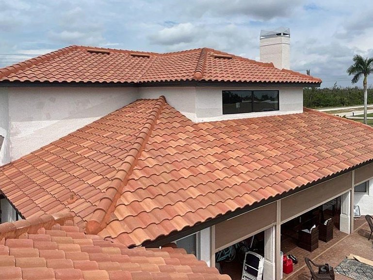 House with terracotta tile roof and covered patio area.